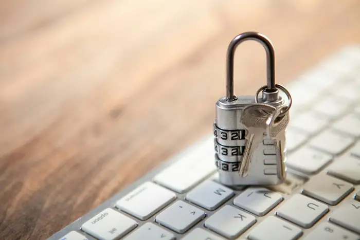 A padlock and keys resting on a keyboard